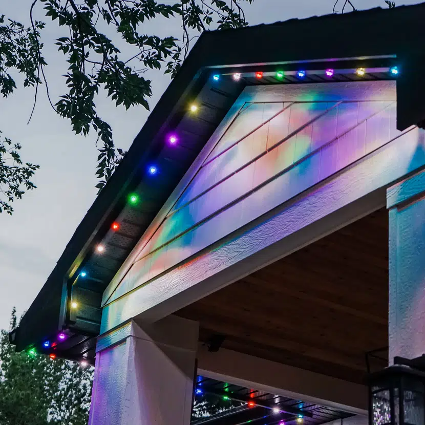 Colour-changing LED track lighting on gable and porch