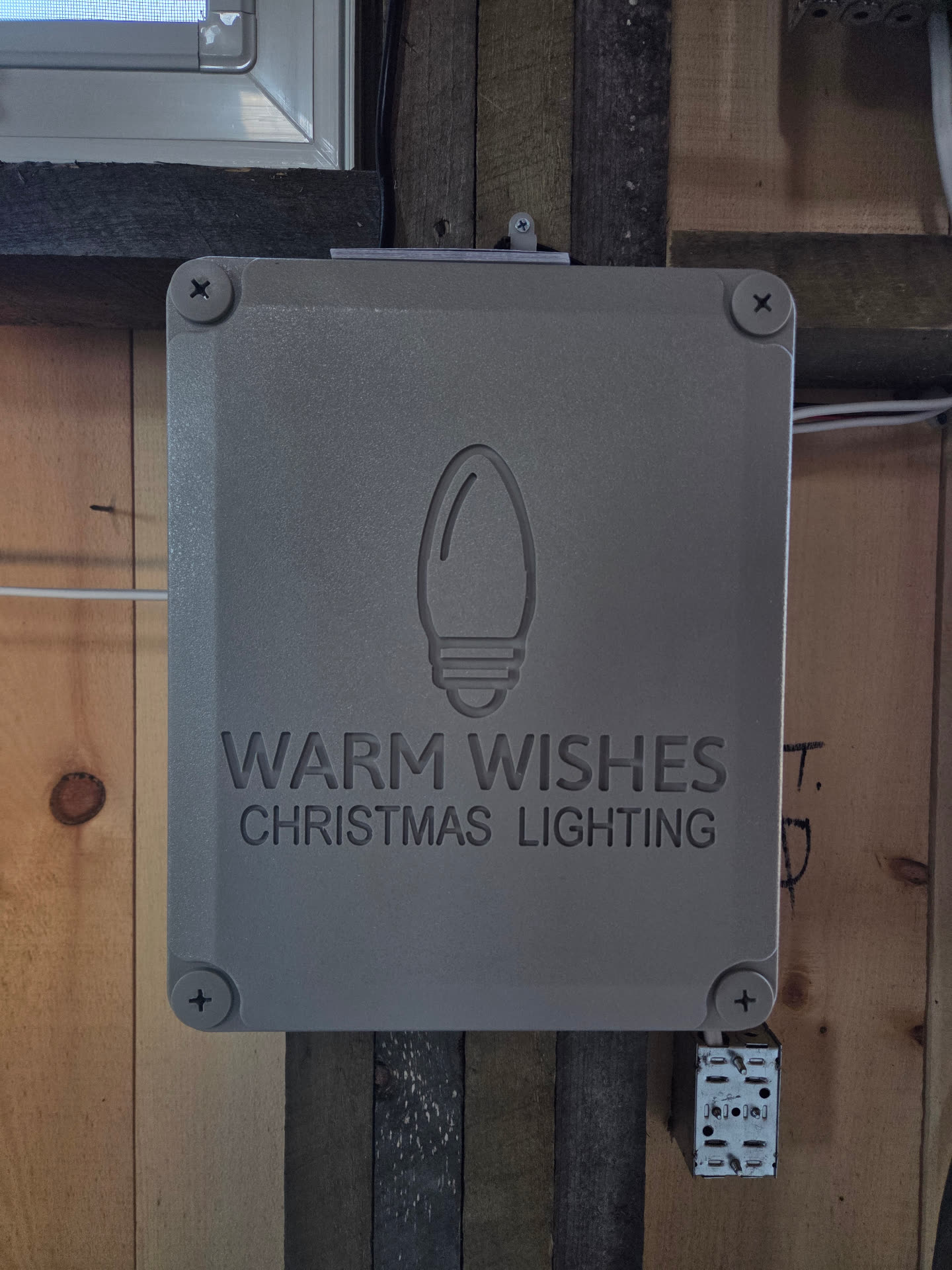 Grey Warm Wishes Christmas Lighting control box mounted inside the barn