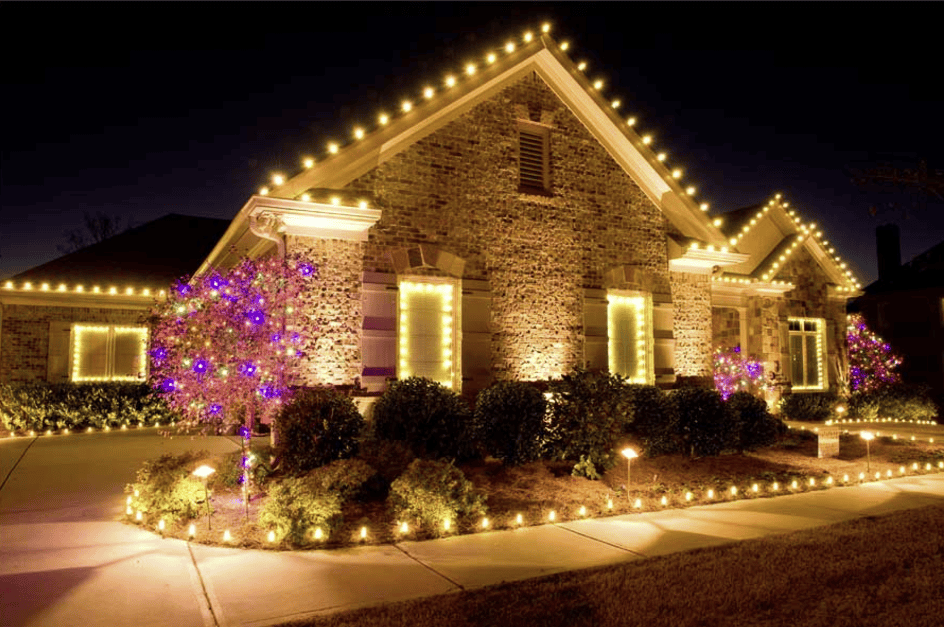 Seasonal Christmas light display with wreaths, garland and wrapped trees